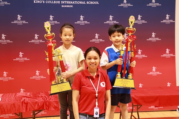 2 Boys with large chess trophies from the King's Bangkok Chess Championship