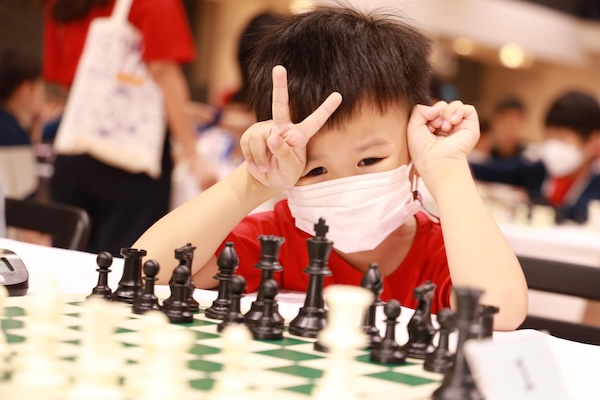 Very small boy playing chess at the King's Bangkok Chess Championship