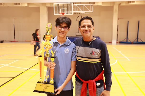 A father and son with trophy at the King's Bangkok Chess Championship