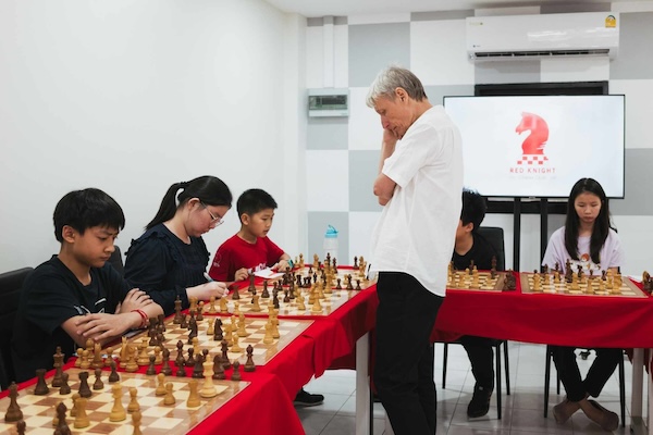 Grandmaster Vladimir Lazarev in deep thought in thinking of next chess move at Red Knight Chess Club for a simul event.